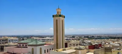 a clock tower in the middle of a city at Fes Serenity - Appartement Suites Medina in Fès