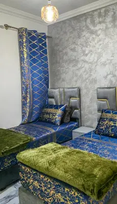 a room with two beds with blue and green sheets at Fes Serenity - Appartement Suites Medina in Fès