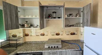 a kitchen with a counter with a stove and shelves at Fes Serenity - Appartement Suites Medina in Fès