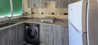 a kitchen with a refrigerator and a washing machine at Fes Serenity - Appartement Suites Medina in Fès