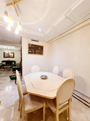 a dining room with a table and chairs at Prestigia Fes Residence - Luxury Stay in Fès