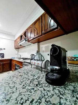 a kitchen with a counter top with a microwave at Prestigia Fes Residence - Luxury Stay in Fès