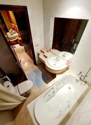a bathroom with a toilet and a sink and a tub at Prestigia Fes Residence - Luxury Stay in Fès