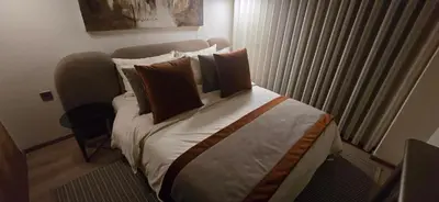 a hotel room with a bed with pillows at Prestigia Fes Residence - Luxury Stay in Fès