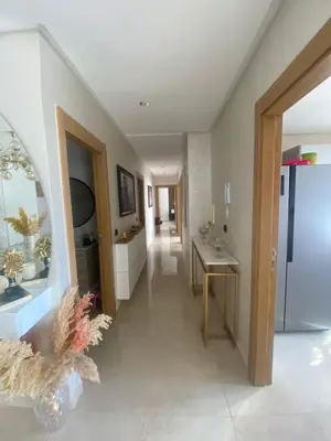 a room with a hallway with a sink and a table at Appartement location hout standing agadir in Oulad Akkou