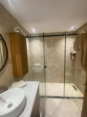 a bathroom with a shower with a toilet and a sink at Appartement location hout standing agadir in Oulad Akkou