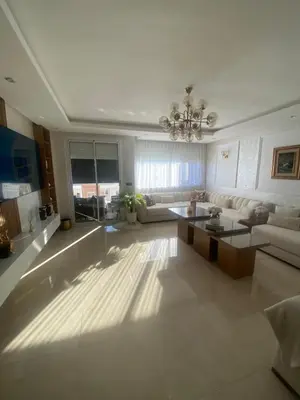a large living room with a couch and a table at Appartement location hout standing agadir in Oulad Akkou