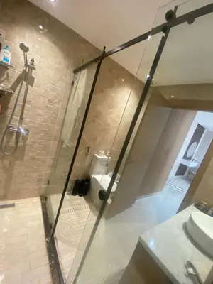 a glass shower in a bathroom with a toilet at Appartement location hout standing agadir in Oulad Akkou