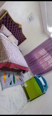 a bedroom with a bed with colorful pillows at فيلا فاخرة in Imouzzer Kandar