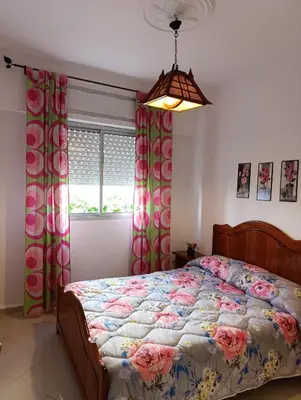 a bedroom with a bed and a window at Appartement martil in Oulad Akkou
