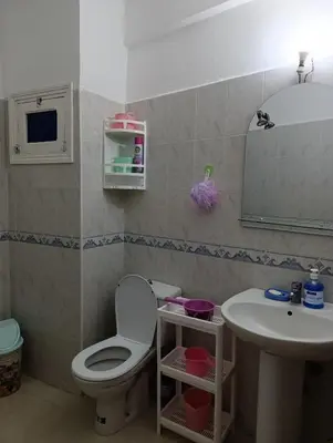 a bathroom with a toilet and a sink at Appartement martil in Oulad Akkou