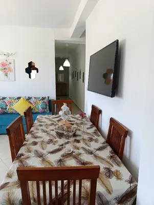 a dining room with a table and a television at Appartement martil in Oulad Akkou