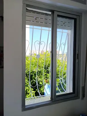 a window with a view of a balcony at Appartement martil in Oulad Akkou