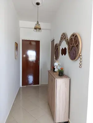 a hallway with a table and plates on the wall at Appartement martil in Oulad Akkou