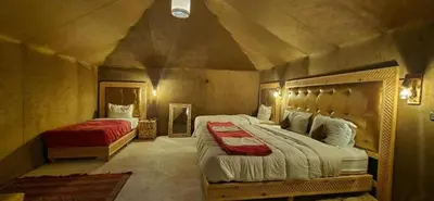 a bedroom with two beds in a room at Fantastic Luxury Camp in Merzouga