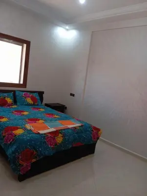a bedroom with a bed with a colorful comforter at Safi City in Oulad Akkou
