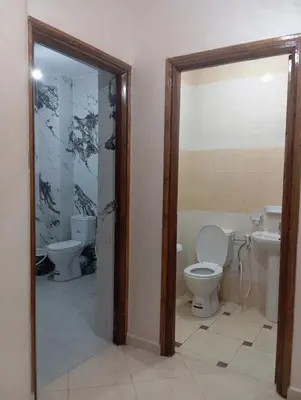 a bathroom with two toilets and a sink at Safi City in Oulad Akkou