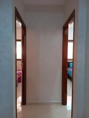 a hallway with two mirrors in a room at Safi City in Oulad Akkou