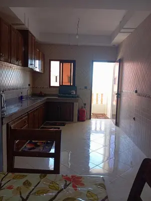 a kitchen with a table and a counter top at Safi City in Oulad Akkou