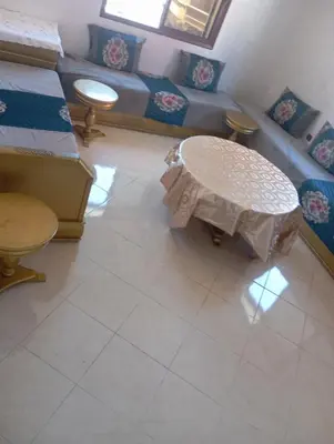 a living room with a table and a couch at Safi City in Oulad Akkou
