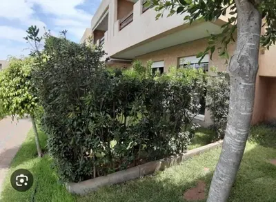 a large bush in front of a building at Al Jazeera beach in Zaouia Sidi Rahkal