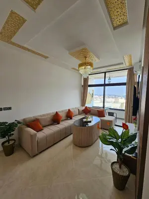 a living room with a couch and a table at Chaker's Luxury Apartment Fez in Fès