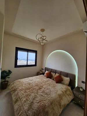 a bedroom with a large bed and a window at Chaker's Luxury Apartment Fez in Fès