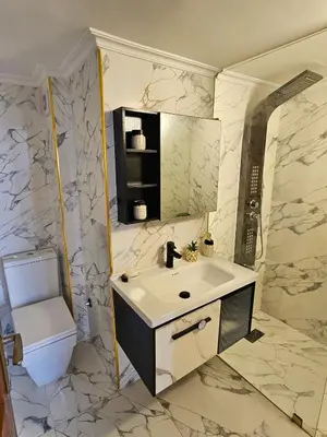 a bathroom with a sink and a toilet at Chaker's Luxury Apartment Fez in Fès