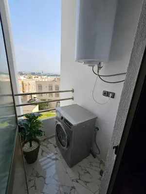 a washing machine in a room with a balcony at Chaker's Luxury Apartment Fez in Fès