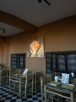 a dining room with wooden tables and chairs at Auberge Etoile Filante d Or Ait Ben Haddou in Aït Ben Haddou