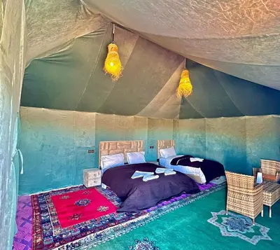 a bedroom with a bed in a tent at Habibi Luxury Camp in Merzouga