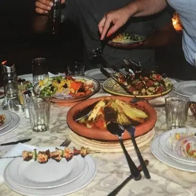 a table with plates of food on top of it at Habibi Luxury Camp in Merzouga