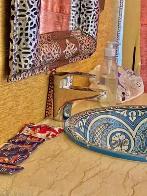a table with a plate and a bottle of water at Habibi Luxury Camp in Merzouga