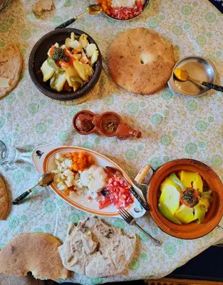 a table with plates of food on a table at Maison d'hotes Dar Aisha