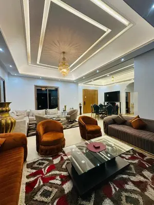 a large living room with a couch and a table at Villa Paradise in Ahnaou