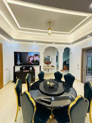 a dining room with a black table and chairs at Villa Paradise in Ahnaou