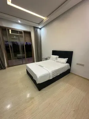 a bedroom with a large bed in a room at Villa Paradise in Ahnaou
