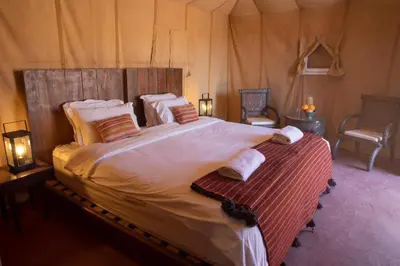a bedroom with a large bed in a tent at Camp fire Dreams in Merzouga