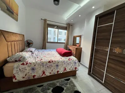 a bedroom with a bed and a window at Beautiful apartment for rent in Oulad Akkou
