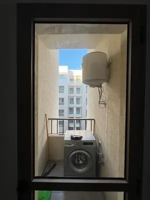 a washing machine in a room with a window at Beautiful apartment for rent in Oulad Akkou