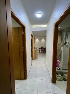 a hallway with two doors and a tile floor at Beautiful apartment for rent in Oulad Akkou