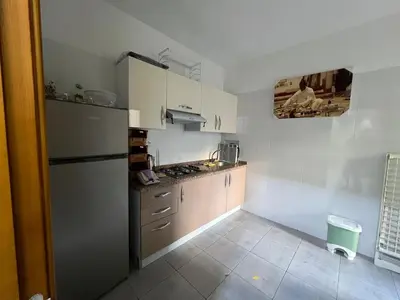 a kitchen with a stainless steel refrigerator and cabinets at Beautiful apartment for rent in Oulad Akkou