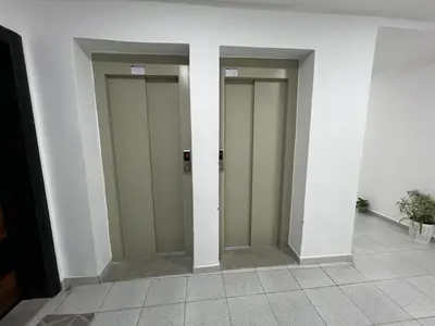 a row of three elevator doors in a building at Beautiful apartment for rent in Oulad Akkou