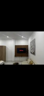 a living room with couches and a clock on the wall at Hatim bien-être in Oulad Akkou