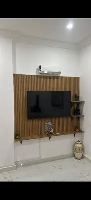 a flat screen tv on a wall in a room at Hatim bien-être in Oulad Akkou