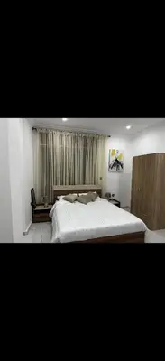 a bedroom with a large bed and a window at Hatim bien-être in Oulad Akkou