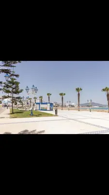 a view of a street with palm trees in the distance at Vistas Al mar in Oulad Akkou