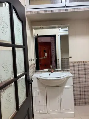 a bathroom with a sink and a mirror at Vistas Al mar in Oulad Akkou