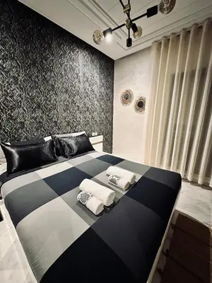 a large black and white bed in a room at Cozy apart in the heart of fez in Fès