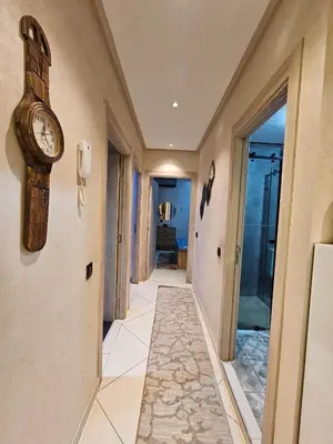 a hallway with a clock on the wall at Hay mabroka in Oulad Akkou